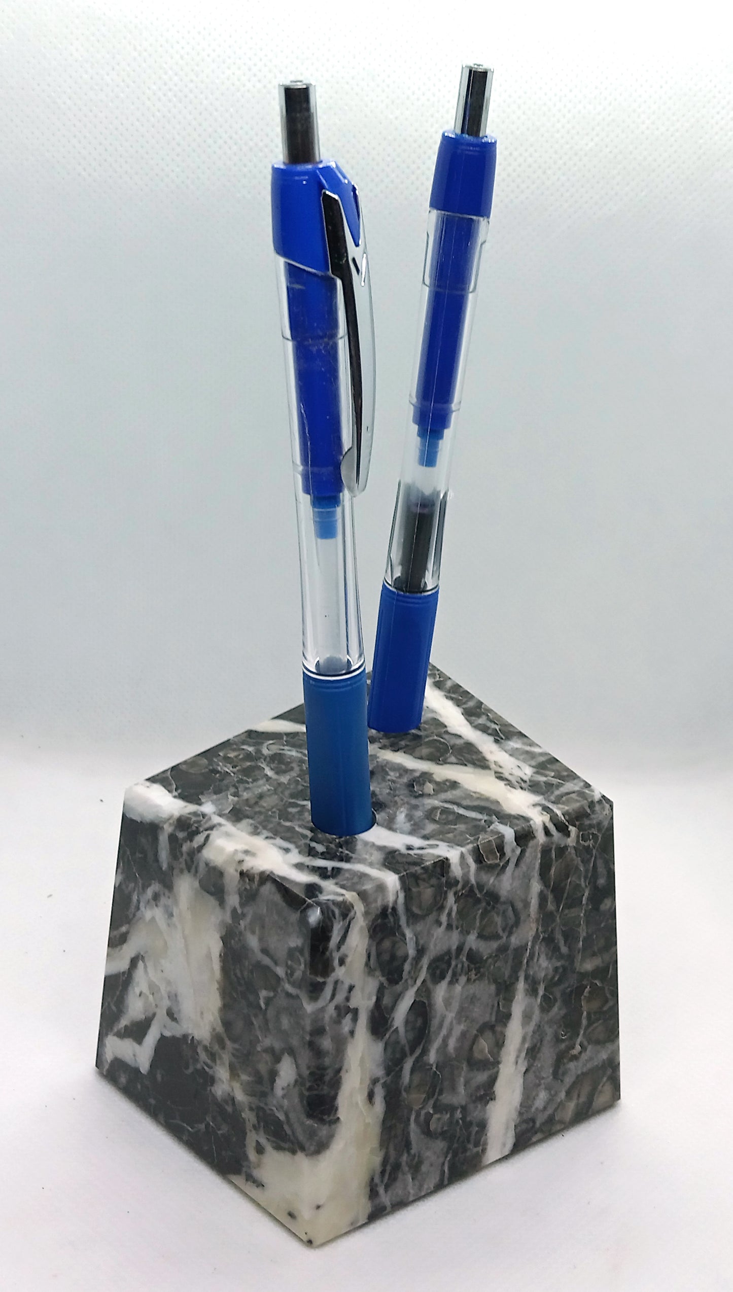 A limestone pencil stand with fossils and calcite veins