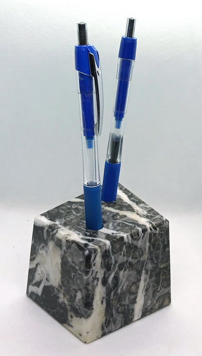 A limestone pencil stand with fossils and calcite veins