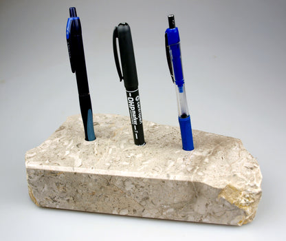 A stand for pencils made of coral and stromatops